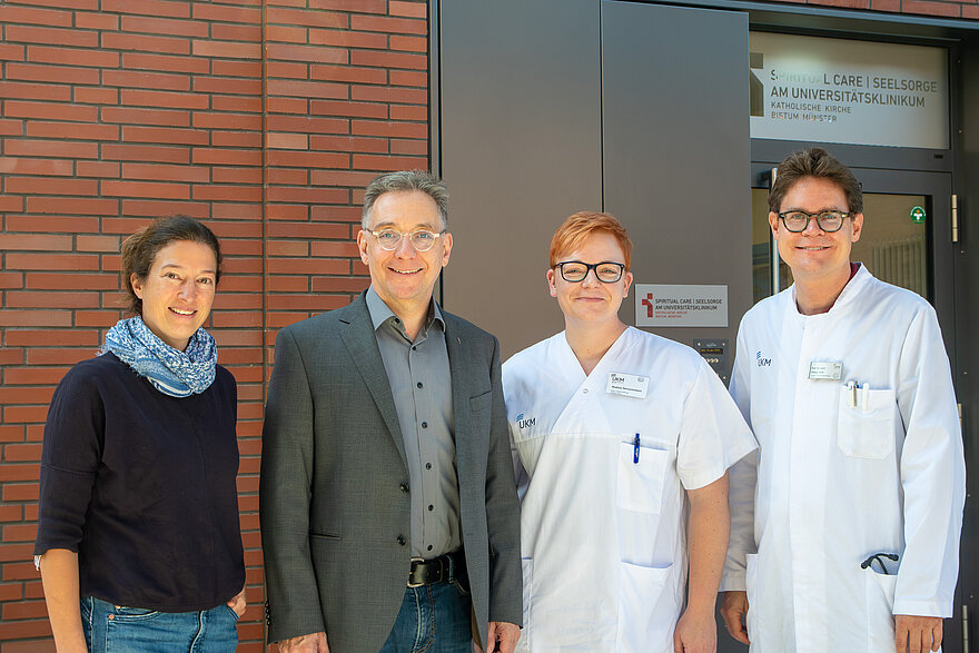 Margarita Temming, Dr. Leo Wittenbecher, Nadine Gerversmann und Professor Dr. Philipp Lenz (von links) stehen vor den Büros der Klinikseelsorge.