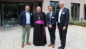 Martin Varwick, David Rönker, Bischof Felix Genn und Markus Nolte stehen vor einem Gebäude. Martin Varwick, David Rönker, Bischof Felix Genn und Markus Nolte stehen vor einem Gebäude.