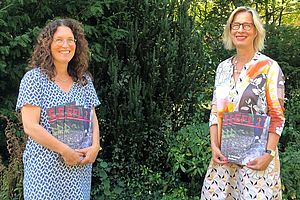 Andrea Beer und Andrea Stachon-Groth stehen in einem Garten und halten mehrere Exemplare des Jahresberichtes in den Händen. Andrea Beer und Andrea Stachon-Groth stehen in einem Garten und halten mehrere Exemplare des Jahresberichtes in den Händen.