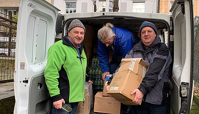 Pater Marek (links) beim Ausladen eines Kleintransporters.