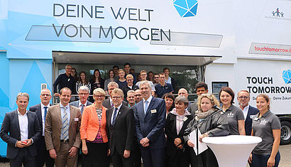 Bundesbildungsministerin Karliczek und weitere Besucher vor dem Truck.