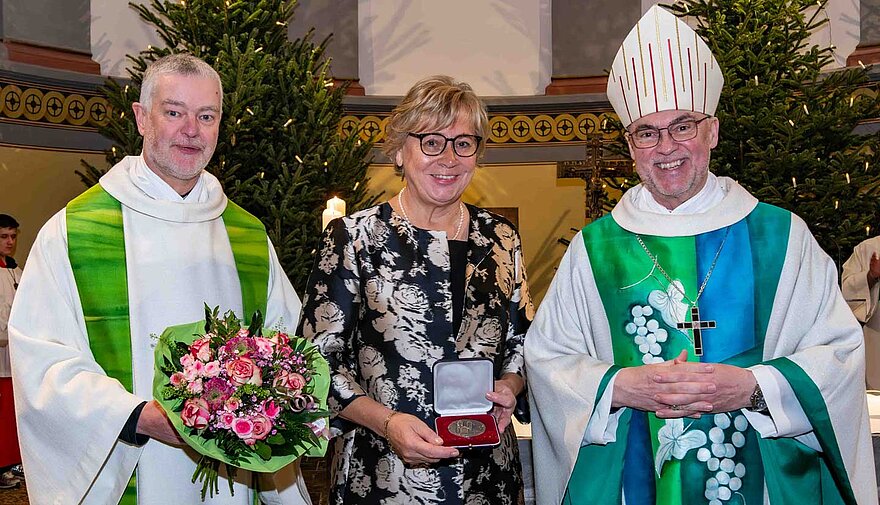 Pfarrer Stefan Keller (links) gehörte zu den ersten Gratulanten, nachdem Conny Graßhoff (Mitte) die Auszeichnung durch Weihbischof Rolf Lohmann (rechts) überreicht wurde. 