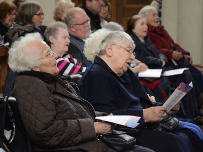 Ältere Menschen, die in der Kirche singen.