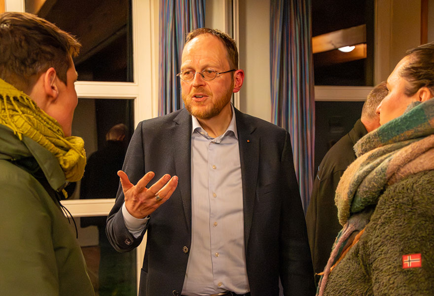 Pfarrer Jörg Hagemann ist mit zwei Frauen im Gespräch.