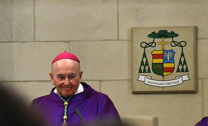 Bischof Felix Genn vor seinem Wappen im St.-Paulus-Dom in Münster